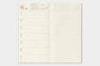An open weekly planner page with cream-colored grid paper pages, showing dates from March 15th to 21st with blank time slots on the left and a grided memo  page on the right.