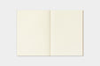 An open blank notebook with cream-colored pages, displayed flat against a light gray background.