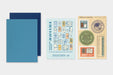 TRAVELER'S notebook Refill- Passport Size- 2027 Weekly Diary displayed on a light gray background, featuring two blue Diaries, a light blue card labeled 'Travelers' 2027 Guide', and one sticker sheet with travel-themed labels.