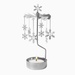 A silver metal winter-themed candle holder featuring a wind spinner with hanging snowflakes and a lit tealight candle in a round silver holder, set against a plain white background.
