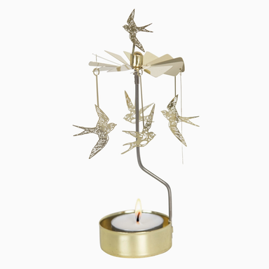 A gold-toned metal bird mobile candle holder with several hanging bird ornaments and a lit tealight candle in a round gold holder, shown against a plain white background.