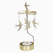 A gold-toned metal bird mobile candle holder with several hanging bird ornaments and a lit tealight candle in a round gold holder, shown against a plain white background.