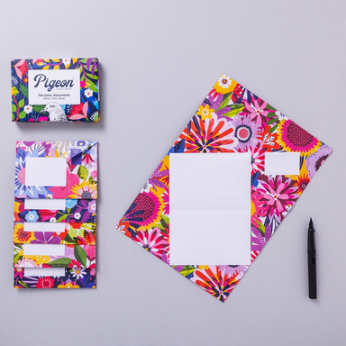 Colorful stationery set with floral design on a gray background