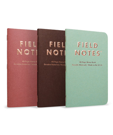 Field Notes Lucky Edition 3-Pack- Three 'Field Notes' notebooks in different colors on a white background