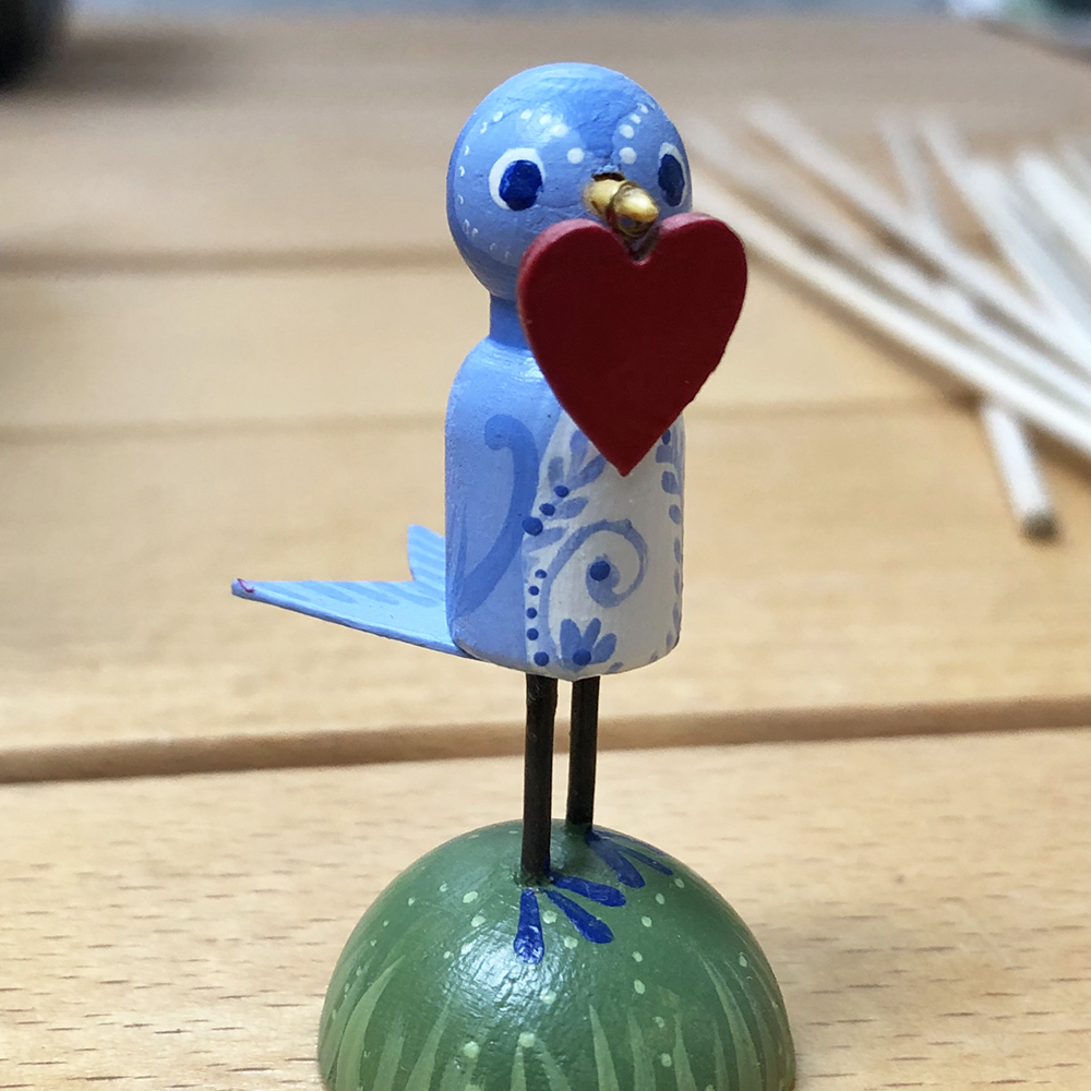 Two Feathered Friends class sample with blue bird holding a heart