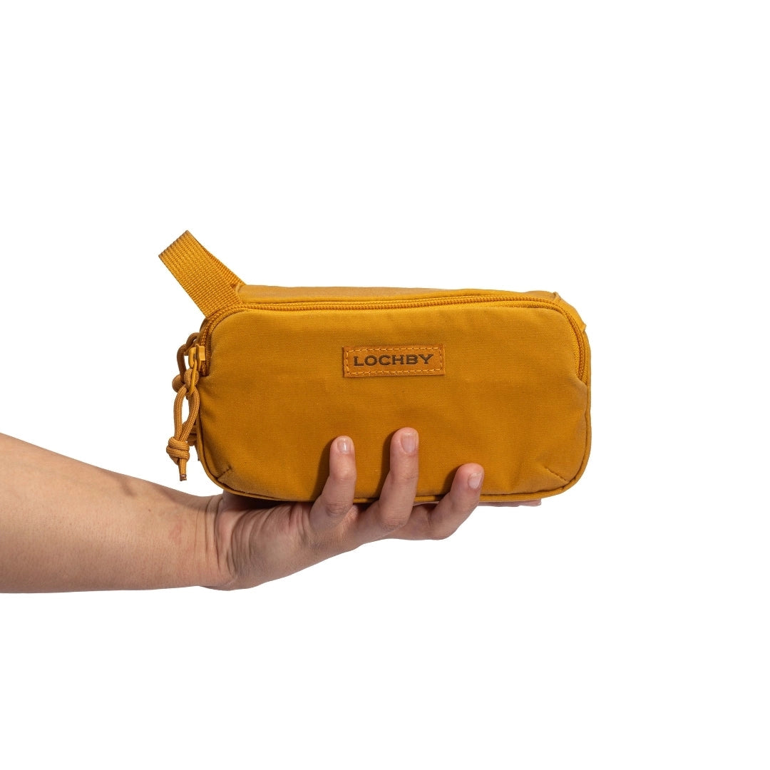 Honey Mini Venture Pouch held by a hand on a white background, with 'LOCHBY' branding.