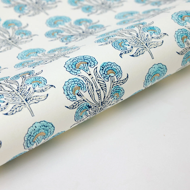 Floral-patterned paper with turquoise and dark blue flowers on a white background with gold accents- detail