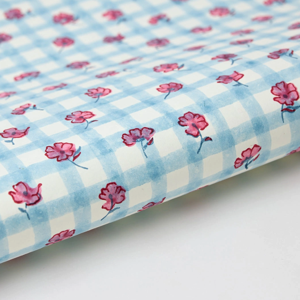 Floral-patterned paper with pink flowers on a blue and white checkered background- detail