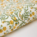Floral and bird patterned paper with yellow flowers and green leaves on a white background- detail