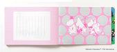 Moomin Writing and Crafting Papers- example pages- the left page is light pink with a white lined writing area, and the right page has a pink and gray polka-dot pattern with white Moomin character illustrations.