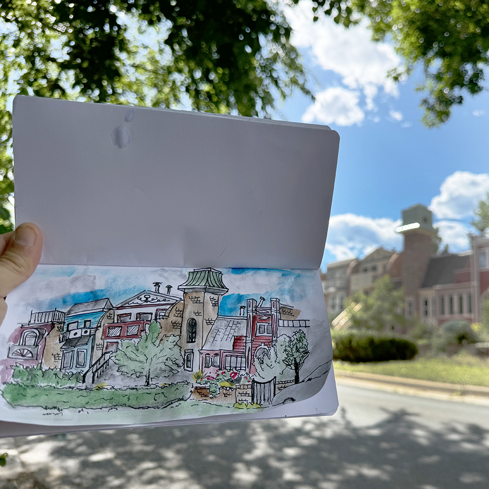 Sketch Crawl class example on Pearl Street with the sketched houses in background.