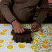 Block printing process- priting leaf pattern with block in hand