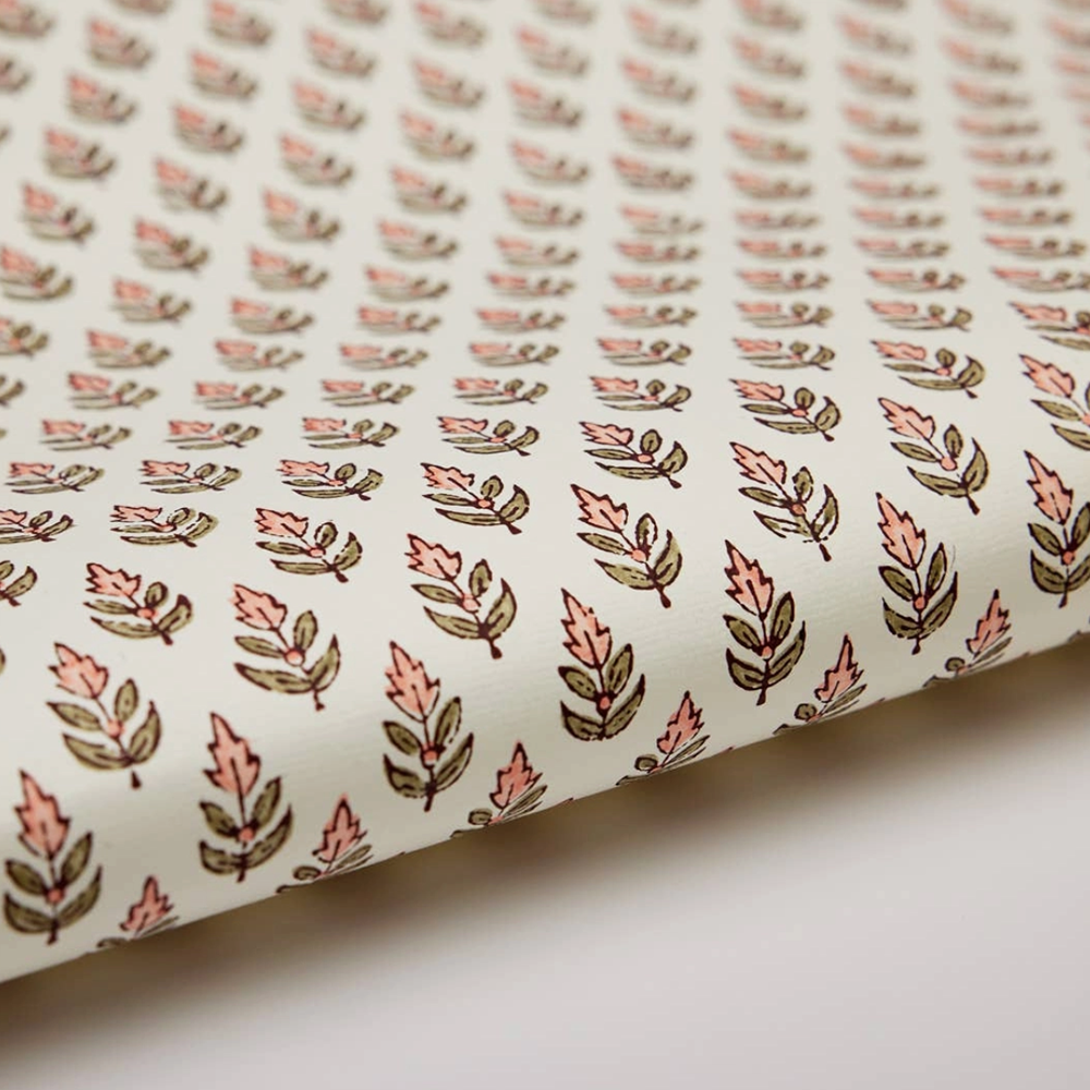 Roll of paper with a floral repeat pattern on a white background