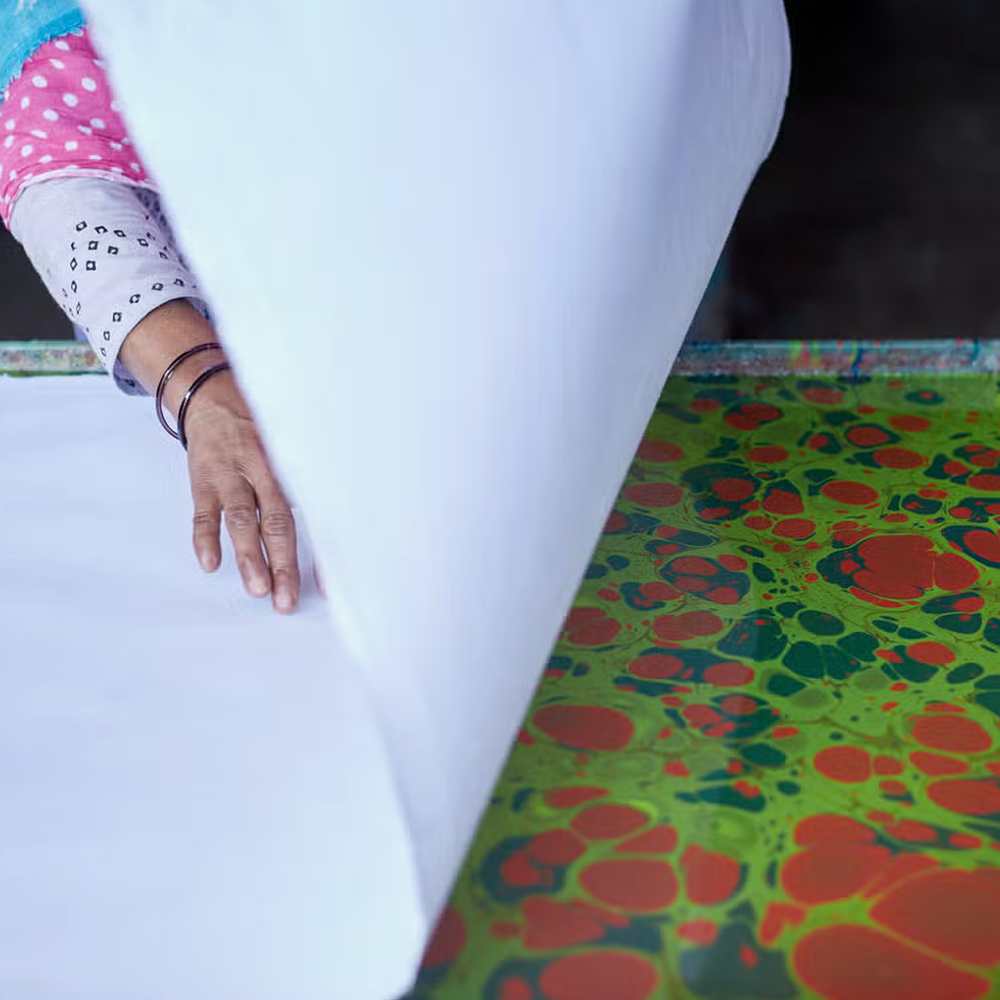 paper marbling process- White sheet being laid on color