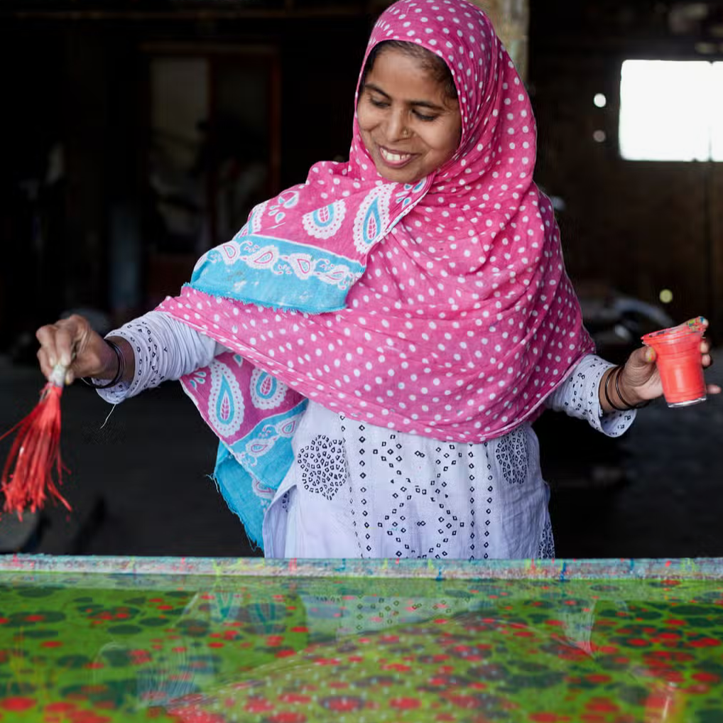 Showing paper marbling process- woman creating marbled pattern on  water