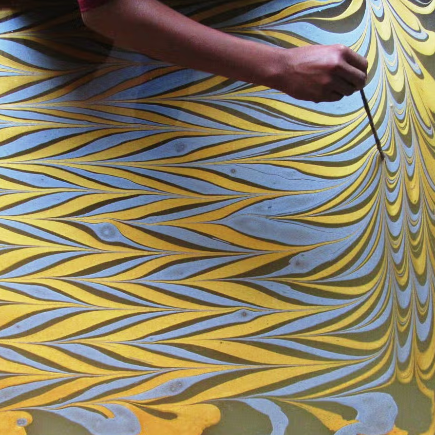  Paper marbling process- person creating marbled pattern on water