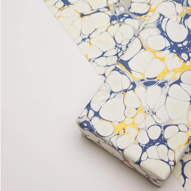 Handmade Indian Cotton Paper- Marbled bubble- blue and gold on white base- full sheet with a wrapped package on top