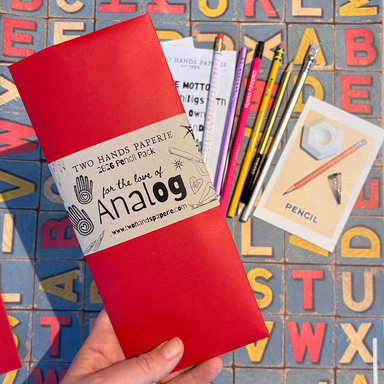 THP 2026 Limited Edition Pencil Pack- red packaging and pencils shown in background on alphabet paper