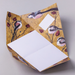 Colorful origami folded letter shown open with long-tailed tit themed design on a light gray background