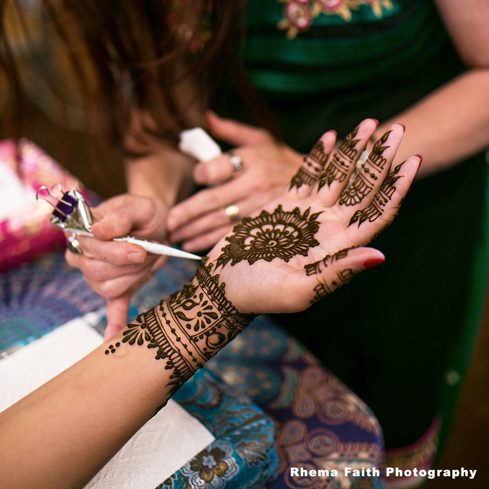 Designs in Henna work in progess on the palm of a hand