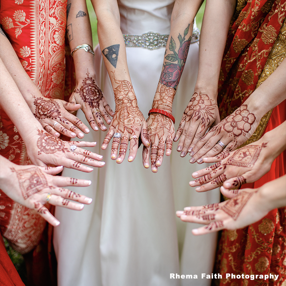 Designs in Henna on the backs of hands on a bridal party