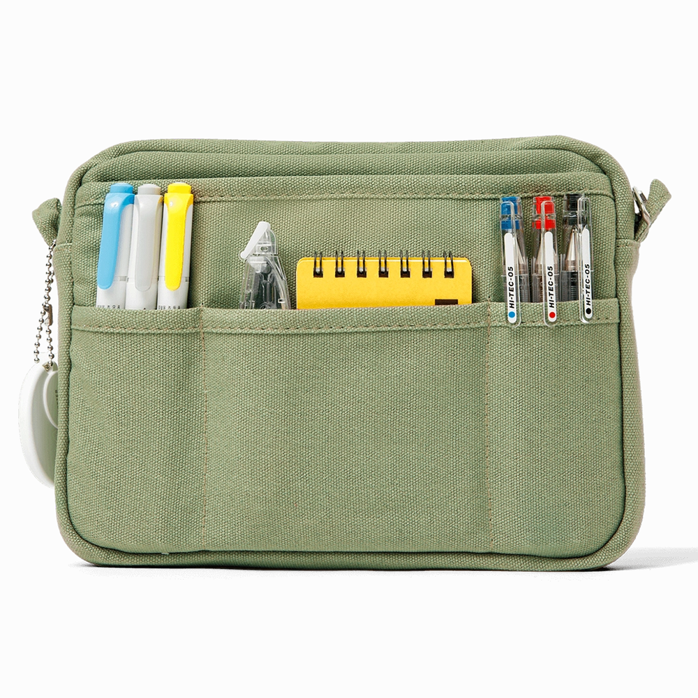 An olive green canvas pouch with multiple front pockets holding pens, a yellow notepad, shown on a white background.