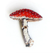 Mushroom-shaped brooch with red cap and white stem on a white background