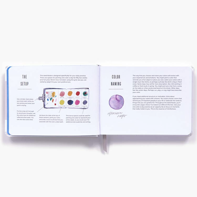 An open Color A Day page spread showing printed instructions and color reference pages, photographed on a clean white background.