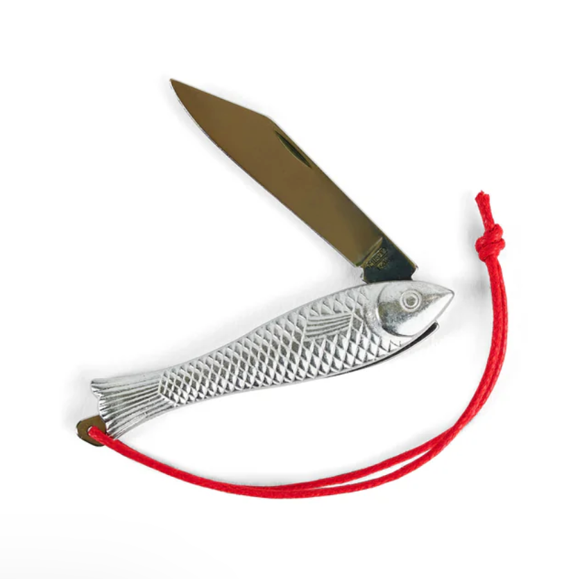 Fish-shaped knife shown open with a red string on a white background