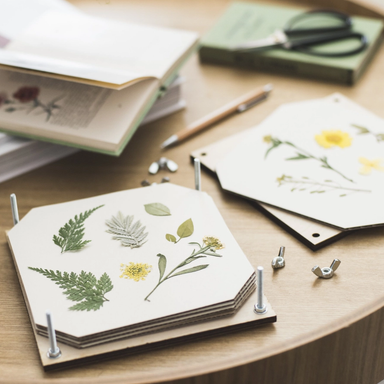 Flower Press shown open on a table with pressed flowers