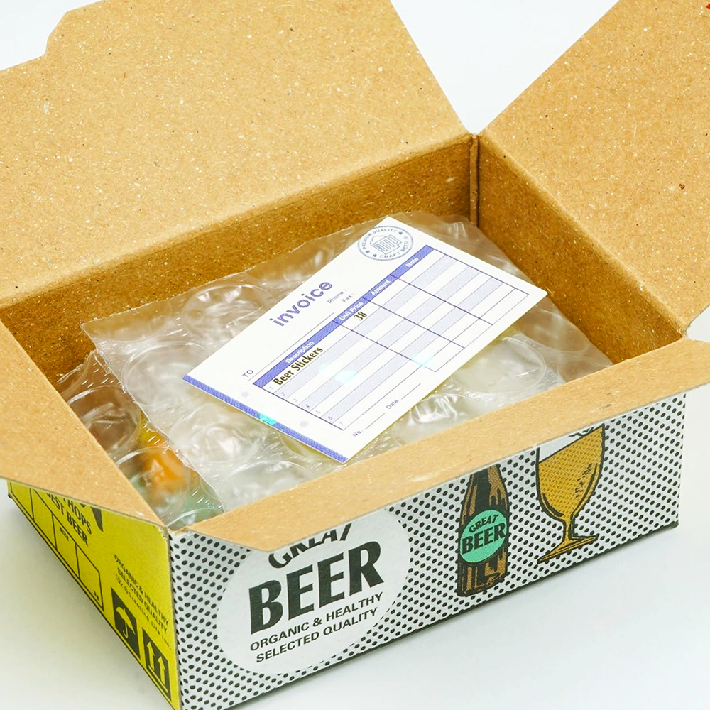 Open cardboard box with packing material and an invoice inside, labeled 'Great Beer'.