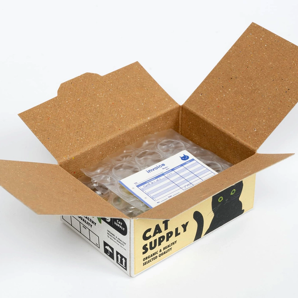 Open cardboard box labeled 'Cat Supply' with packing material and an invoice inside on a white background.