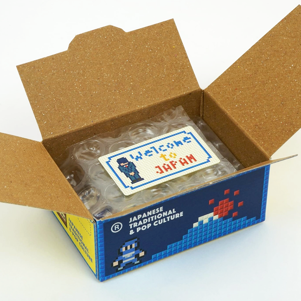 Open box with clear plastic items and a 'Welcome to Japan' sticker on a white background