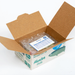 Open cardboard box with a fish on a white background with packing material and invoice