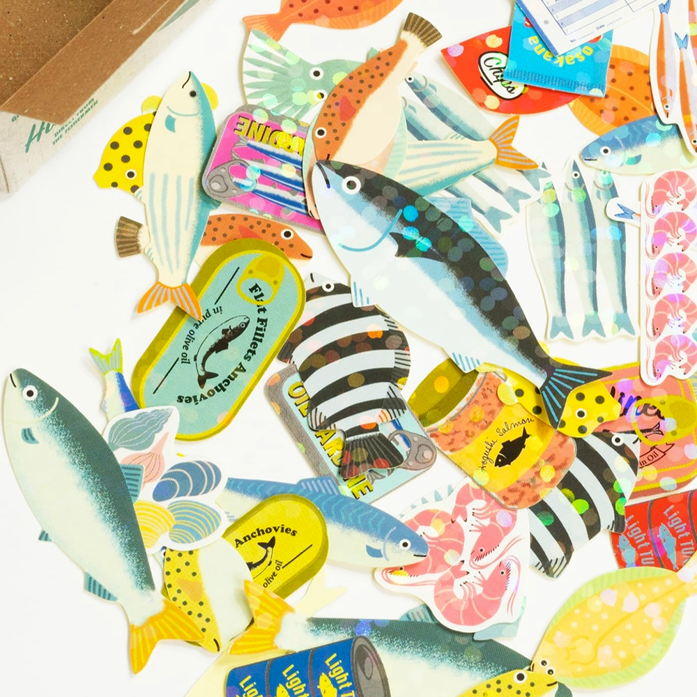 Collection of colorful fish-shaped stickers with various designs on a white background.