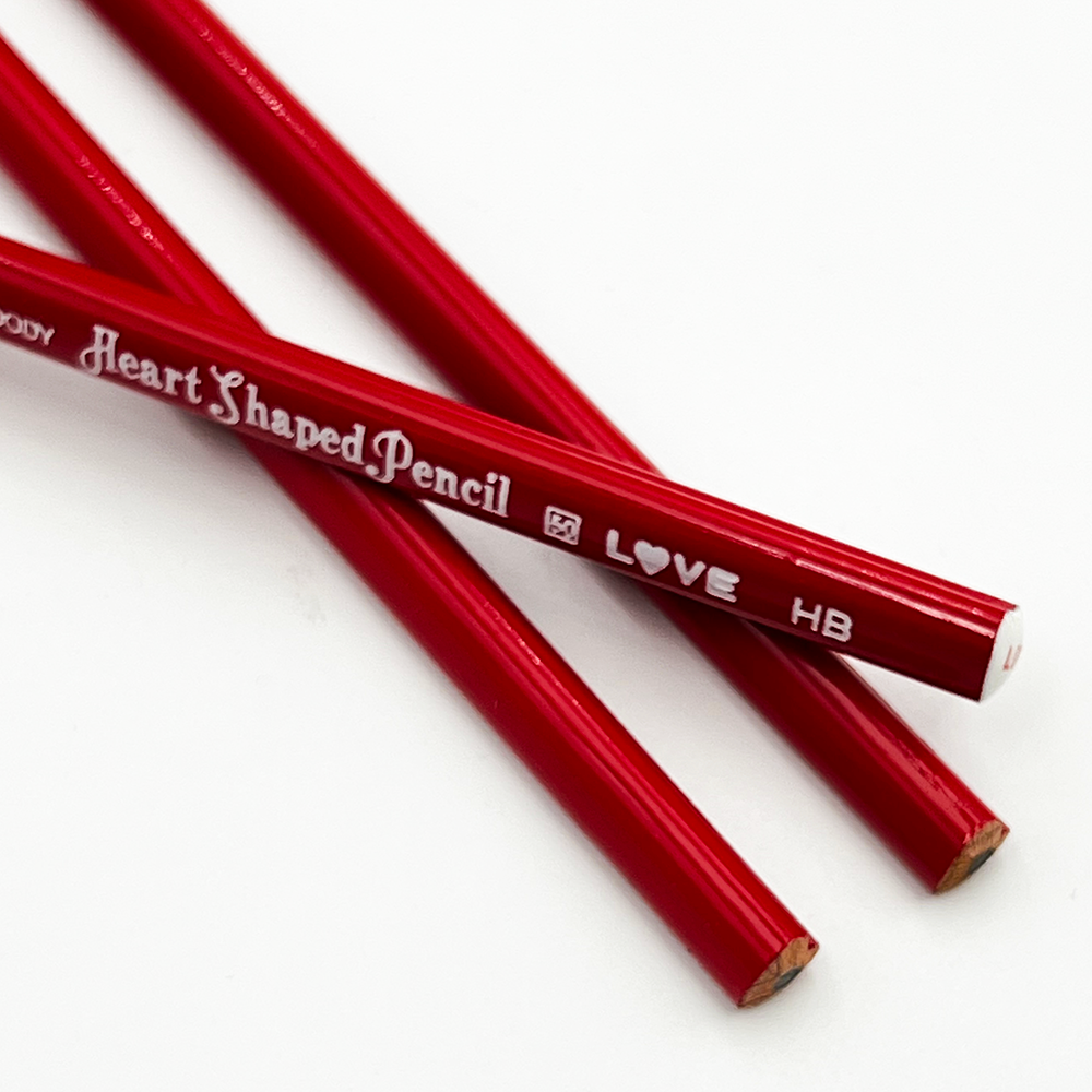 Red heart-shaped pencils on a white background
