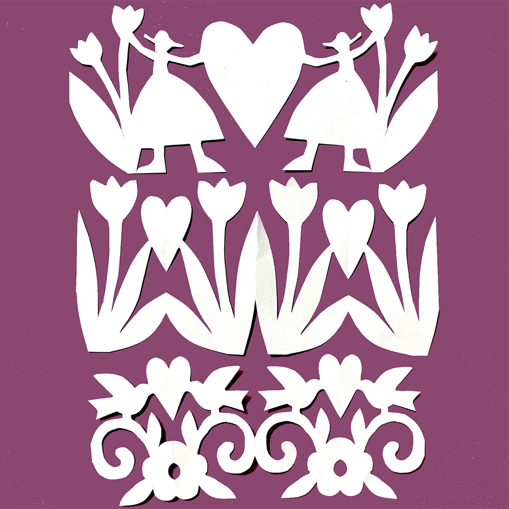 White paper cutout designs featuring stylized figures, tulips, hearts, and decorative scrollwork, arranged on a solid purple background.