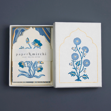Pack of cards with floral design and 'paper mirchi' branding on a dark background