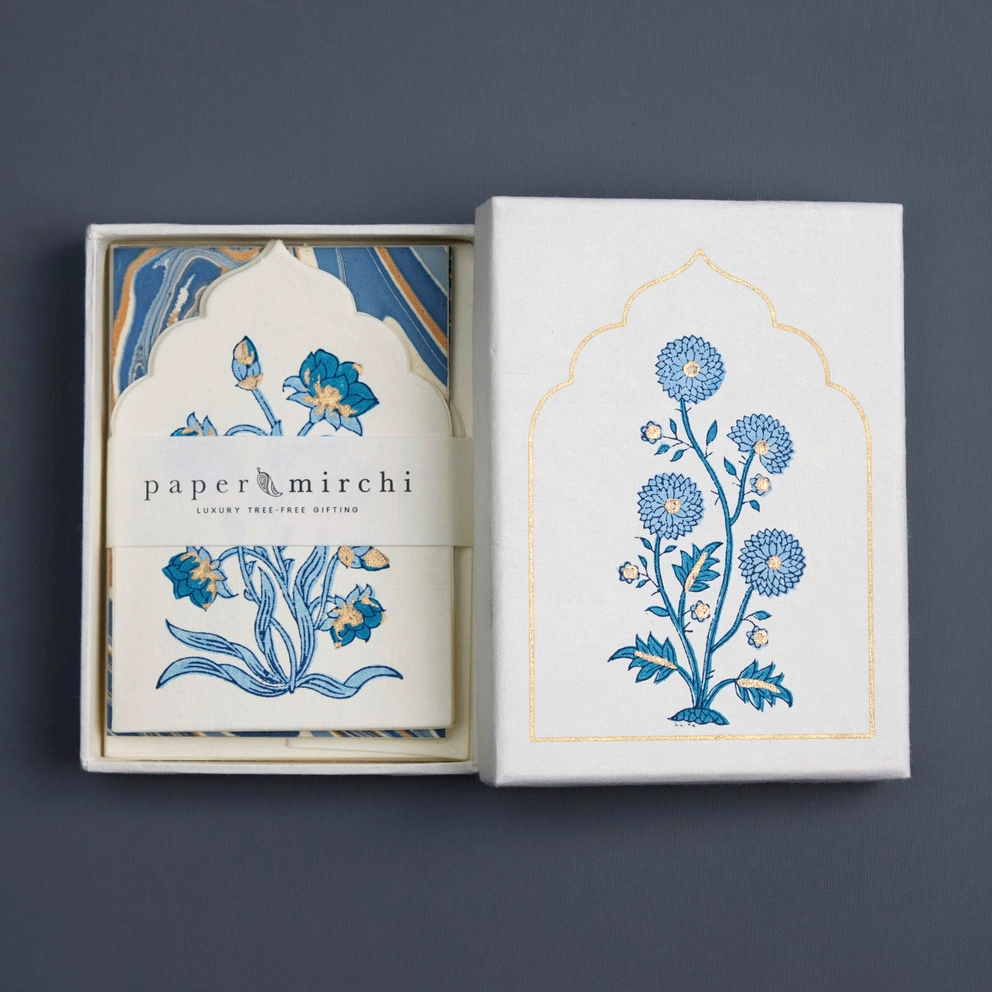 Pack of cards with floral design and 'paper mirchi' branding on a dark background