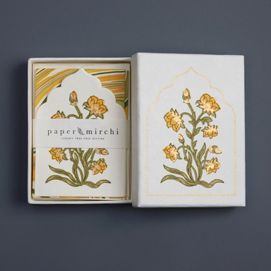 Decorative box with floral design and 'paper mirchi' branding on a dark background