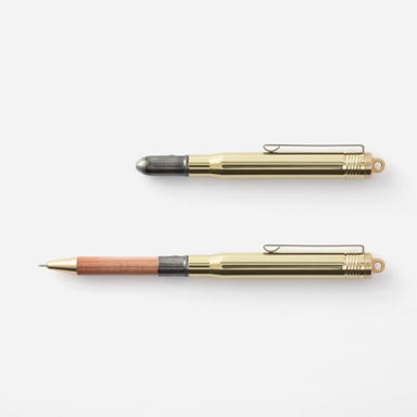 The brass body piece holds a black ink, ball pen cartridge