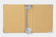 The Storage Binder uses metal rods to hold Midori Traveler's Notebook Refills. 